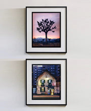 Load image into Gallery viewer, The traditional Italian Tobacconist shop, here in a Swiss Cottage style building set against a vast urban apartment block. 