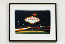 Load image into Gallery viewer, Taken upon leaving Las Vegas, and featured in Richard Heeps' 'Dream in Colour' series, this piece features a classic American neon sign, with the Las Vegas lights disappearing into the distance. 