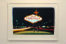 Load image into Gallery viewer, Taken upon leaving Las Vegas, and featured in Richard Heeps' 'Dream in Colour' series, this piece features a classic American neon sign, with the Las Vegas lights disappearing into the distance. 