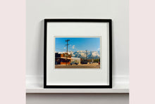 Load image into Gallery viewer, There is a cinematic style to this artwork, 'Lone Pine', taken in a former movie town in California where many Western films were made. Taken outside Richard's iconic interior photograph 'Bonanza Café', set in the Owens Valley against a mountainous  backdrop.