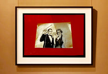 Load image into Gallery viewer, 'Magic Act' is a sepia toned vintage image laid on a bright red backdrop. This photograph was captured at the Red Lodge, a stop often used by performers as they traveled across the country.