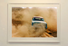 Load image into Gallery viewer, 'Mercury in the Dust I' shows a classic American car donut driving on a Norfolk beach in the East of England. This photograph was captured at Hemsby Rock and Roll weekend, and is part of Richard Heeps' Man's Ruin' series.