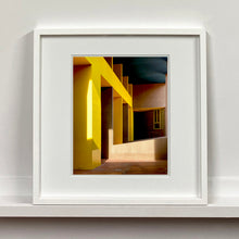 Load image into Gallery viewer, Monte Amiata housing, Gallaratese Quarter, Milan. Yellow brutalist architecture street photography by Richard Heeps framed in white.
