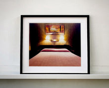 Load image into Gallery viewer, An ongoing subject of Richard's photography is the motel room. In this instance, photographed at the Lariat Motel in Fallon, Nevada. It is also often a significant location within American film and TV culture. For example, It is the backdrop for the iconic scene in the Hollywood film psycho. In this atmospheric image, the bed lights are joined together conveying a sense of coupling.