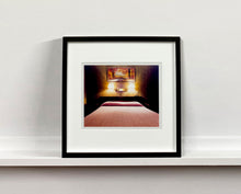 Load image into Gallery viewer, An ongoing subject of Richard's photography is the motel room. In this instance, photographed at the Lariat Motel in Fallon, Nevada. It is also often a significant location within American film and TV culture. For example, It is the backdrop for the iconic scene in the Hollywood film psycho. In this atmospheric image, the bed lights are joined together conveying a sense of coupling.