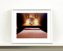 Load image into Gallery viewer, An ongoing subject of Richard's photography is the motel room. In this instance, photographed at the Lariat Motel in Fallon, Nevada. It is also often a significant location within American film and TV culture. For example, It is the backdrop for the iconic scene in the Hollywood film psycho. In this atmospheric image, the bed lights are joined together conveying a sense of coupling.