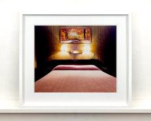 Load image into Gallery viewer, An ongoing subject of Richard's photography is the motel room. In this instance, photographed at the Lariat Motel in Fallon, Nevada. It is also often a significant location within American film and TV culture. For example, It is the backdrop for the iconic scene in the Hollywood film psycho. In this atmospheric image, the bed lights are joined together conveying a sense of coupling.