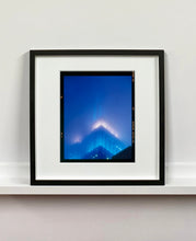 Load image into Gallery viewer, 'NOMAD II (Film Rebate)', New York. Richard Heeps has photographed the iconic Empire State building in the mist. The NOMAD sequence of photographs capture the art deco architecture illuminated by changing colours, and is part of Richard's street photography portfolio which depict the colour, fabric and structure of cities with distinct style. This 6x7 format edition is bordered by the Kodak film rebate. 