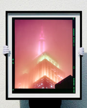 Load image into Gallery viewer, 'NOMAD III (Film Rebate)', New York. Richard Heeps has photographed the iconic Empire State building in the mist. The NOMAD sequence of photographs capture the art deco architecture illuminated by changing colours, and is part of Richard's street photography portfolio which depict the colour, fabric and structure of cities with distinct style. This 6x7 format edition is bordered by the Kodak film rebate.