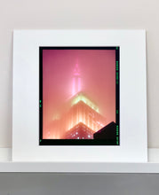 Load image into Gallery viewer, 'NOMAD III (Film Rebate)', New York. Richard Heeps has photographed the iconic Empire State building in the mist. The NOMAD sequence of photographs capture the art deco architecture illuminated by changing colours, and is part of Richard's street photography portfolio which depict the colour, fabric and structure of cities with distinct style. This 6x7 format edition is bordered by the Kodak film rebate.