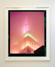 Load image into Gallery viewer, 'NOMAD III (Film Rebate)', New York. Richard Heeps has photographed the iconic Empire State building in the mist. The NOMAD sequence of photographs capture the art deco architecture illuminated by changing colours, and is part of Richard's street photography portfolio which depict the colour, fabric and structure of cities with distinct style. This 6x7 format edition is bordered by the Kodak film rebate.