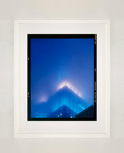 Load image into Gallery viewer, 'NOMAD II (Film Rebate)', New York. Richard Heeps has photographed the iconic Empire State building in the mist. The NOMAD sequence of photographs capture the art deco architecture illuminated by changing colours, and is part of Richard's street photography portfolio which depict the colour, fabric and structure of cities with distinct style. This 6x7 format edition is bordered by the Kodak film rebate. 