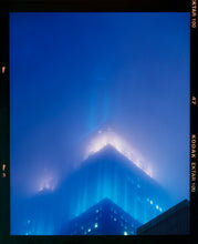 Load image into Gallery viewer, 'NOMAD II (Film Rebate)', New York. Richard Heeps has photographed the iconic Empire State building in the mist. The NOMAD sequence of photographs capture the art deco architecture illuminated by changing colours, and is part of Richard's street photography portfolio which depict the colour, fabric and structure of cities with distinct style. This 6x7 format edition is bordered by the Kodak film rebate. 