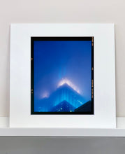 Load image into Gallery viewer, 'NOMAD II (Film Rebate)', New York. Richard Heeps has photographed the iconic Empire State building in the mist. The NOMAD sequence of photographs capture the art deco architecture illuminated by changing colours, and is part of Richard's street photography portfolio which depict the colour, fabric and structure of cities with distinct style. This 6x7 format edition is bordered by the Kodak film rebate. 