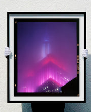 Load image into Gallery viewer, 'NOMAD V (Film Rebate)', New York. Richard Heeps has photographed the iconic Empire State building in the mist. The NOMAD sequence of photographs capture the art deco architecture illuminated by changing colours, and is part of Richard's street photography portfolio which depict the colour, fabric and structure of cities with distinct style. This 6x7 format edition is bordered by the Kodak film rebate. 