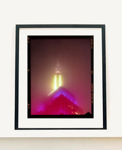 Load image into Gallery viewer, NOMAD VII (Film Rebate), New York, photography by Richard Heeps capturing the iconic Empire State building in the mist. Part of a sequence of photographs capturing the art deco architecture illuminated in changing colours. This 6x7 format edition is bordered by the Kodak film rebate. This artwork is part of Richard's portfolio of street photography he is building up which depict the colour, fabric and structure of cities with distinct style