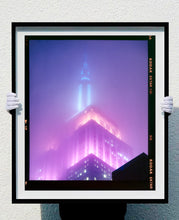 Load image into Gallery viewer, 'NOMAD VIII (Film Rebate)', New York. Richard Heeps has photographed the iconic Empire State building in the mist. The NOMAD sequence of photographs capture the art deco architecture illuminated by changing colours, and is part of Richard's street photography portfolio which depict the colour, fabric and structure of cities with distinct style. This 6x7 format edition is bordered by the Kodak film rebate. 