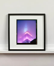 Load image into Gallery viewer, 'NOMAD VIII (Film Rebate)', New York. Richard Heeps has photographed the iconic Empire State building in the mist. The NOMAD sequence of photographs capture the art deco architecture illuminated by changing colours, and is part of Richard's street photography portfolio which depict the colour, fabric and structure of cities with distinct style. This 6x7 format edition is bordered by the Kodak film rebate. 