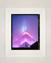 Load image into Gallery viewer, 'NOMAD VIII (Film Rebate)', New York. Richard Heeps has photographed the iconic Empire State building in the mist. The NOMAD sequence of photographs capture the art deco architecture illuminated by changing colours, and is part of Richard's street photography portfolio which depict the colour, fabric and structure of cities with distinct style. This 6x7 format edition is bordered by the Kodak film rebate. 