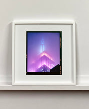 Load image into Gallery viewer, 'NOMAD VIII (Film Rebate)', New York. Richard Heeps has photographed the iconic Empire State building in the mist. The NOMAD sequence of photographs capture the art deco architecture illuminated by changing colours, and is part of Richard's street photography portfolio which depict the colour, fabric and structure of cities with distinct style. This 6x7 format edition is bordered by the Kodak film rebate. 