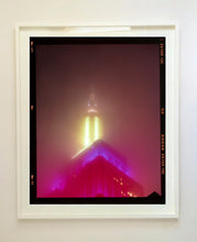 Load image into Gallery viewer, NOMAD VII (Film Rebate), New York, photography by Richard Heeps capturing the iconic Empire State building in the mist. Part of a sequence of photographs capturing the art deco architecture illuminated in changing colours. This 6x7 format edition is bordered by the Kodak film rebate. This artwork is part of Richard's portfolio of street photography he is building up which depict the colour, fabric and structure of cities with distinct style