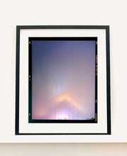 Load image into Gallery viewer, 'NOMAD VI (Film Rebate)', New York. Richard Heeps has photographed the iconic Empire State building in the mist. The NOMAD sequence of photographs capture the art deco architecture illuminated by changing colours, and is part of Richard's street photography portfolio which depict the colour, fabric and structure of cities with distinct style. This 6x7 format edition is bordered by the Kodak film rebate. 