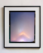 Load image into Gallery viewer, 'NOMAD VI (Film Rebate)', New York. Richard Heeps has photographed the iconic Empire State building in the mist. The NOMAD sequence of photographs capture the art deco architecture illuminated by changing colours, and is part of Richard's street photography portfolio which depict the colour, fabric and structure of cities with distinct style. This 6x7 format edition is bordered by the Kodak film rebate. 