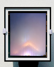 Load image into Gallery viewer, 'NOMAD VI (Film Rebate)', New York. Richard Heeps has photographed the iconic Empire State building in the mist. The NOMAD sequence of photographs capture the art deco architecture illuminated by changing colours, and is part of Richard's street photography portfolio which depict the colour, fabric and structure of cities with distinct style. This 6x7 format edition is bordered by the Kodak film rebate. 