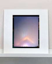 Load image into Gallery viewer, 'NOMAD VI (Film Rebate)', New York. Richard Heeps has photographed the iconic Empire State building in the mist. The NOMAD sequence of photographs capture the art deco architecture illuminated by changing colours, and is part of Richard's street photography portfolio which depict the colour, fabric and structure of cities with distinct style. This 6x7 format edition is bordered by the Kodak film rebate. 