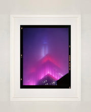 Load image into Gallery viewer, 'NOMAD V (Film Rebate)', New York. Richard Heeps has photographed the iconic Empire State building in the mist. The NOMAD sequence of photographs capture the art deco architecture illuminated by changing colours, and is part of Richard's street photography portfolio which depict the colour, fabric and structure of cities with distinct style. This 6x7 format edition is bordered by the Kodak film rebate. 