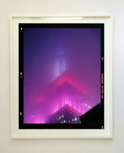 Load image into Gallery viewer, 'NOMAD V (Film Rebate)', New York. Richard Heeps has photographed the iconic Empire State building in the mist. The NOMAD sequence of photographs capture the art deco architecture illuminated by changing colours, and is part of Richard's street photography portfolio which depict the colour, fabric and structure of cities with distinct style. This 6x7 format edition is bordered by the Kodak film rebate. 