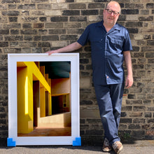 Load image into Gallery viewer, Monte Amiata housing, Gallaratese Quarter, Milan. Yellow brutalist architecture street photography by Richard Heeps framed in white.