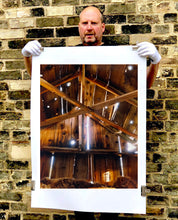 Load image into Gallery viewer, Light breaks through the cracks in the barn on the movie set of Clint Eastwood's Western film 'The Outlaw Josey Wales'. Captured in Kanab, Utah, which was the setting of many Western movies. Photographed by Richard Heeps for his 'Dream in Colour' series.