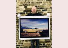 Load image into Gallery viewer, 'Chevy at the Diner' was photographed in Bisbee, Arizona in 2001 but printed by Richard in his darkroom for the first time more recently in 2018. This cinematic artwork that features a vintage yellow chevy parked up at a Diner will take you on an American road trip. 