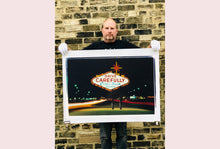 Load image into Gallery viewer, Taken upon leaving Las Vegas, and featured in Richard Heeps' 'Dream in Colour' series, this piece features a classic American neon sign, with the Las Vegas lights disappearing into the distance. 