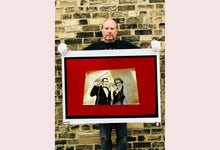 Load image into Gallery viewer, 'Magic Act' is a sepia toned vintage image laid on a bright red backdrop. This photograph was captured at the Red Lodge, a stop often used by performers as they traveled across the country.