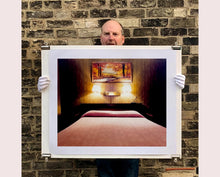 Load image into Gallery viewer, An ongoing subject of Richard's photography is the motel room. In this instance, photographed at the Lariat Motel in Fallon, Nevada. It is also often a significant location within American film and TV culture. For example, It is the backdrop for the iconic scene in the Hollywood film psycho. In this atmospheric image, the bed lights are joined together conveying a sense of coupling.