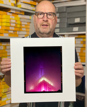 Load image into Gallery viewer, NOMAD I (Film Rebate), New York. Richard Heeps has photographed the iconic Empire State building in the mist. The NOMAD sequence of photographs capture the art deco architecture illuminated by changing colours, and is part of Richard's street photography portfolio which depict the colour, fabric and structure of cities with distinct style. This 6x7 format edition is bordered by the Kodak film rebate. 