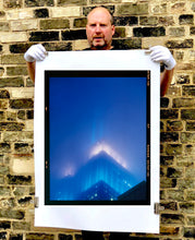 Load image into Gallery viewer, 'NOMAD II (Film Rebate)', New York. Richard Heeps has photographed the iconic Empire State building in the mist. The NOMAD sequence of photographs capture the art deco architecture illuminated by changing colours, and is part of Richard's street photography portfolio which depict the colour, fabric and structure of cities with distinct style. This 6x7 format edition is bordered by the Kodak film rebate. 
