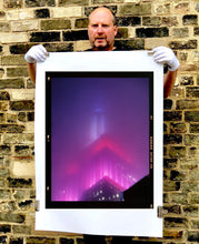Load image into Gallery viewer, 'NOMAD V (Film Rebate)', New York. Richard Heeps has photographed the iconic Empire State building in the mist. The NOMAD sequence of photographs capture the art deco architecture illuminated by changing colours, and is part of Richard's street photography portfolio which depict the colour, fabric and structure of cities with distinct style. This 6x7 format edition is bordered by the Kodak film rebate. 