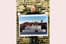 Load image into Gallery viewer, This artwork brings about a romantic dream of living in an RV. Captured in the morning sun at the start of a beautiful Arizona day, this RV is surrounded by both a white picket fence and a beautiful landscape, with the sun tickling the hilltops. Photographed as part of Richard Heeps' 'Dream in Colour' series.