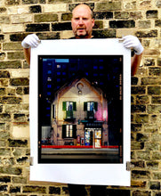 Load image into Gallery viewer, The traditional Italian Tobacconist shop, here in a Swiss Cottage style building set against a vast urban apartment block.