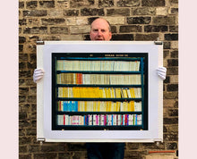 Load image into Gallery viewer, As part of Richard Heeps' series, A Short History of Milan, The Last Kiss features a series of yellow, blue and pink Italian books.