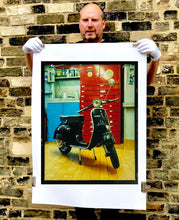 Load image into Gallery viewer, A black vespa against a red, blue and yellow interior. Photographed in Milan, Italy. 