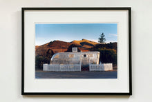 Load image into Gallery viewer, This artwork brings about a romantic dream of living in an RV. Captured in the morning sun at the start of a beautiful Arizona day, this RV is surrounded by both a white picket fence and a beautiful landscape, with the sun tickling the hilltops. Photographed as part of Richard Heeps' 'Dream in Colour' series.
