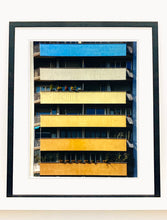 Load image into Gallery viewer, 'Rainbow Apartments' captures Italian design and architecture, showing a multi-coloured nineteen-sixties block of flats. This artwork is part of Richard Heeps' series 'A Short History of Milan' which began in November 2018 for a special project featuring at the Affordable Art Fair Milan 2019, and the series is ongoing. There is a reoccurring linear, structural theme throughout the series, capturing the Milanese use of materials in design such as glass, metal, wood and stone. 