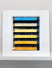 Load image into Gallery viewer, 'Rainbow Apartments' captures Italian design and architecture, showing a multi-coloured nineteen-sixties block of flats. This artwork is part of Richard Heeps' series 'A Short History of Milan' which began in November 2018 for a special project featuring at the Affordable Art Fair Milan 2019, and the series is ongoing. There is a reoccurring linear, structural theme throughout the series, capturing the Milanese use of materials in design such as glass, metal, wood and stone. 