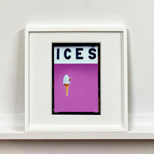 Load image into Gallery viewer, White framed photograph by Richard Heeps.  At the top black letters spell out ICES and below is depicted a 99 icecream cone sitting left of centre against plum coloured background.  