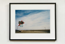 Load image into Gallery viewer, Part of the 'Dream in Colour' series, 'Roy's - Route 66' is one of Richard Heeps' classic American sign artworks featuring the road sign for Roy's Motel, which demonstrates historic Mid-Century Modern Googie architecture. This photograph was capture on the National Trails Highway of U.S. Route 66, in the Mojave Desert town of Amboy in San Bernardino County, California.
