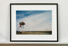 Load image into Gallery viewer, Part of the 'Dream in Colour' series, 'Roy's - Route 66' is one of Richard Heeps' classic American sign artworks featuring the road sign for Roy's Motel, which demonstrates historic Mid-Century Modern Googie architecture. This photograph was capture on the National Trails Highway of U.S. Route 66, in the Mojave Desert town of Amboy in San Bernardino County, California.